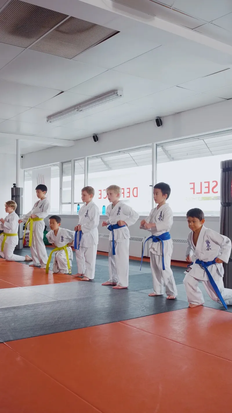 Kids lined up in karate uniforms during the after-school martial arts program in New Westminster