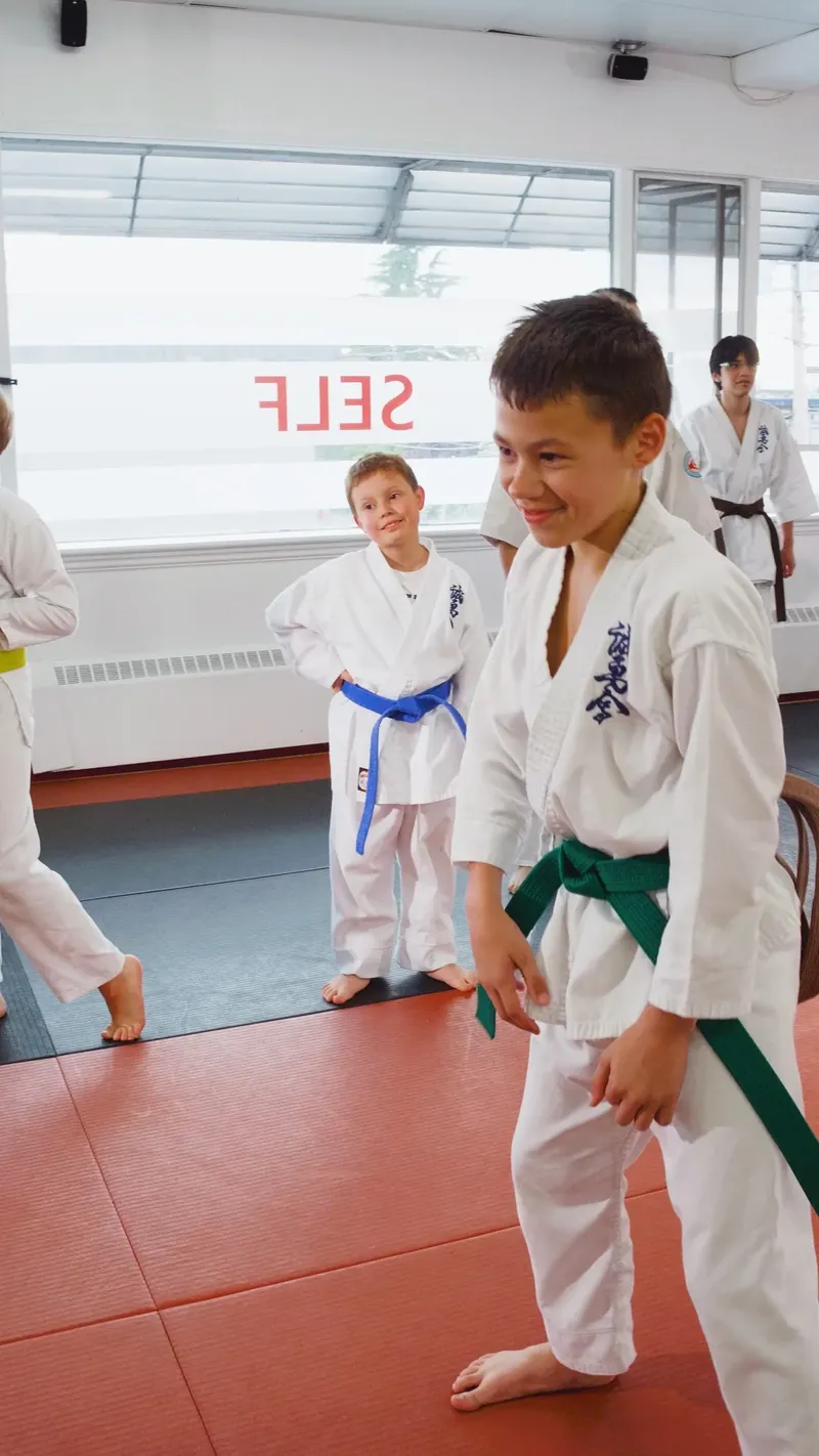 Smiling green belt student during kids karate class at Modern Warrior Academy