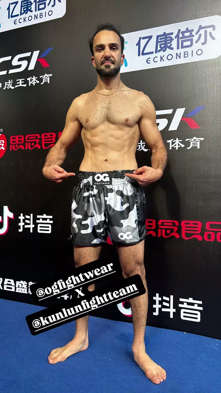 Sasha Tadayoni backstage at Kunlun Fight 107 wearing OG Fightwear x Kunlun Fight Team shorts