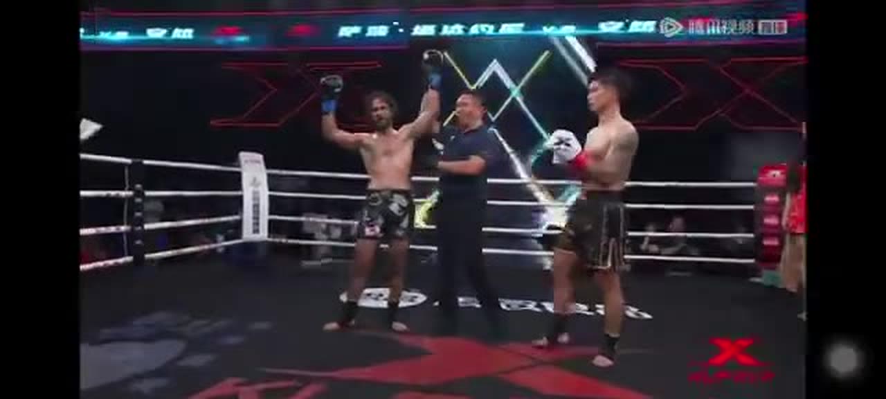 Referee raising Sasha Tadayoni's hand in victory over An Ran at Kunlun Fight 107