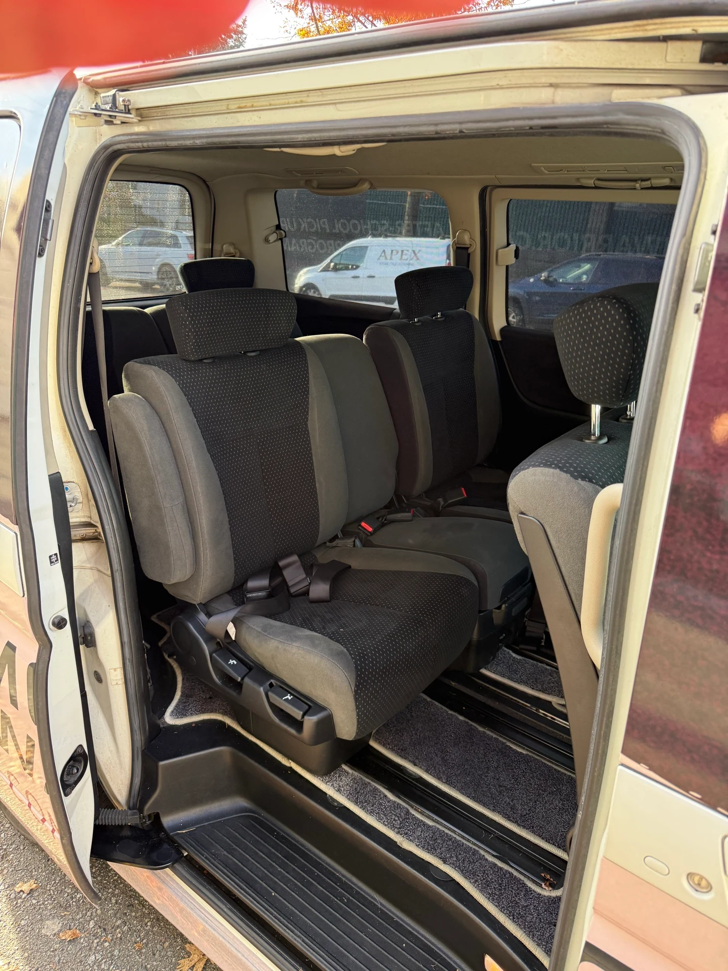 Open side door showing the passenger area of the Modern Warrior pickup van.
