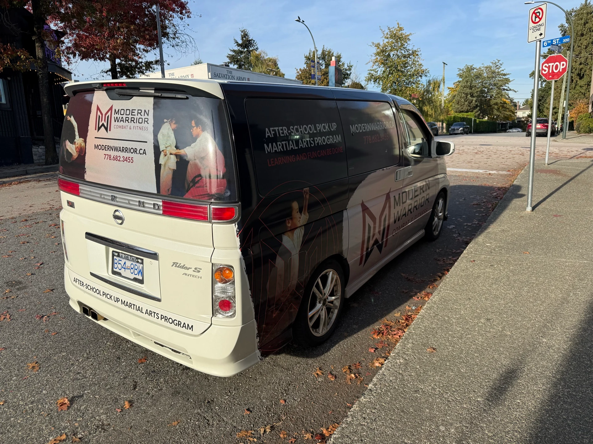 Rear and side of the Modern Warrior van with after-school pickup signage.